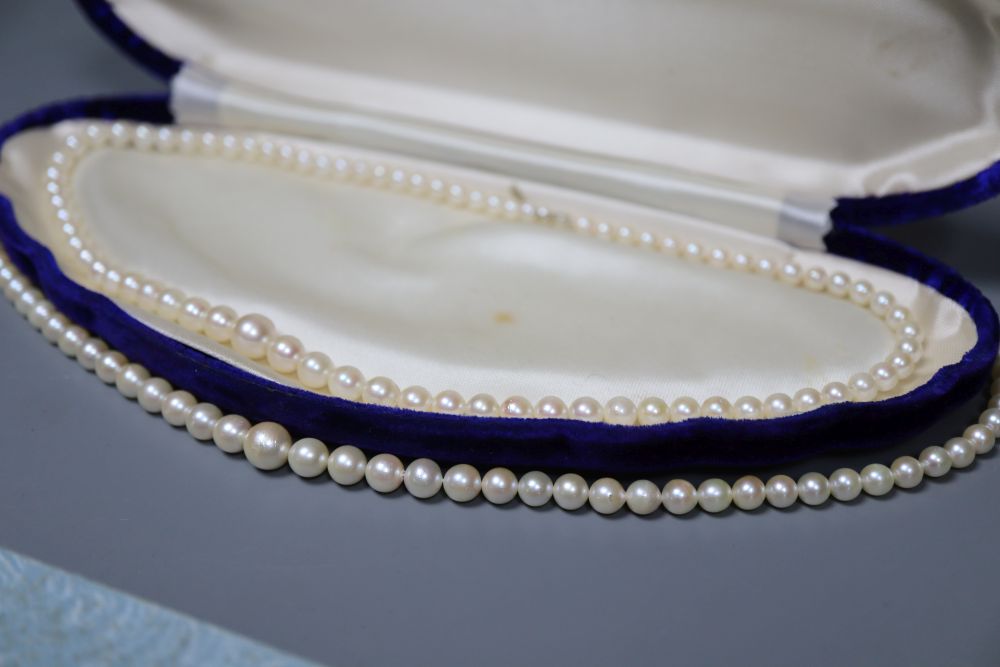 Two single strand cultured pearl necklaces and a simulated pearl necklace.